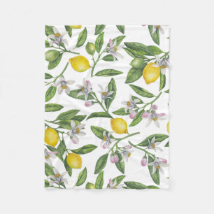 Lemon branches with blossoms and fruit on white fleece blanket