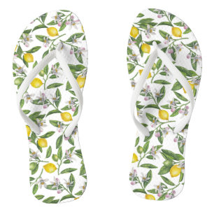 Lemon branches with blossoms and fruit on white flip flops
