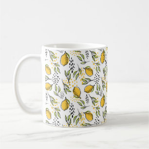 Lemon fruits and green branches on the background coffee mug