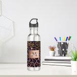 Leopard pattern brown black golden bronze monogram 710 ml water bottle<br><div class="desc">Elegant,  glamourous and feminine with brown,  golden and black leopard pattern,  decorated with golden confetti. Template for your name. A faux bronze  coloured label. Add your name and monogram letter,  black and white text.</div>