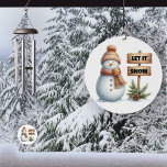 Let it Snow Cosy Winter Snowman Wind Chime<br><div class="desc">Embrace the magic of winter with our delightful Snowman Wind Chime! Featuring an adorable snowman dressed in a cosy hat and scarf, this enchanting piece is sure to bring a smile to your face. Next to him stands a charming sign that says “Let it Snow, ” Surrounded by lush evergreen...</div>