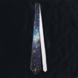 LH 95 in the Large Magellanic Cloud Tie<br><div class="desc">A bluish nebula of glowing hydrogen expands out into the remains of the molecular cloud that collapsed to form the massive stars in this region. The effect is the result of strong stellar winds and high levels of ultraviolet radiation from the largest stars.</div>