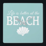 Life Is Better At The Beach Turquoise Square Wall Clock<br><div class="desc">This darling turquoise blue clock features the phrase "Life is better at the beach" in white,  with a cute white shell accent. This is perfect for your beach house or beach themed decor.</div>