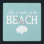 Life Is Better At The Beach Turquoise Square Wall Clock<br><div class="desc">This darling turquoise blue clock features the phrase "Life is better at the beach" in white,  with a cute white shell accent. This is perfect for your beach house or beach themed decor.</div>