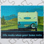 Life Rocks When Your Home Rolls Vintage Camper Jigsaw Puzzle<br><div class="desc">A vintage camper trailer, heading towards mountains in the distance, is the setting for adventure on the road. The fun retro RV camping trailer is blue and cream white with highlights of green. Below the camper is a template that reads: life rocks when your home rolls . The text template...</div>