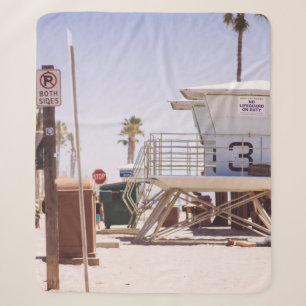 Lifeguard houses under bright skty sherpa blanket