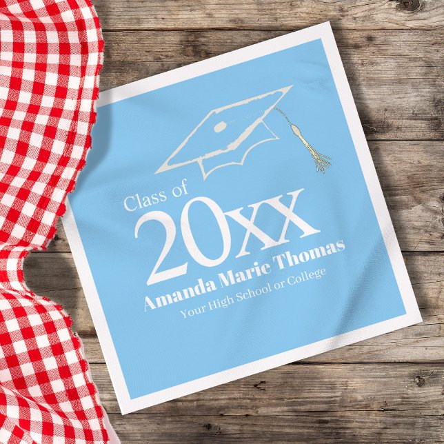 Light Blue Graduation Cap Class of 20XX Name Napkin (Light blue graduation napkin with Class of 20XX, custom name and cap design on table.)