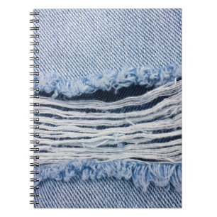 Light blue torn Jeans texture. Notebook
