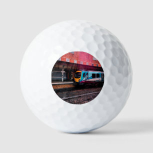 Light blue train at the station golf balls