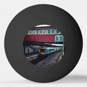 Light blue train, under bridge ping pong ball
