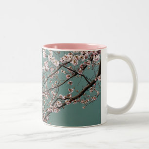 Light pink cherry blossoms on turquois background Two-Tone coffee mug