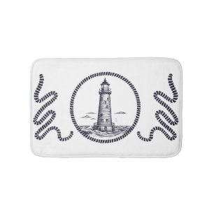 Lighthouse at the sea in round rope frame bath mat