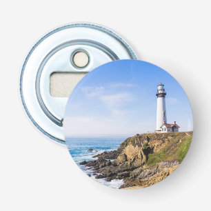 Lighthouse on hill blue sky white house ocean bottle opener