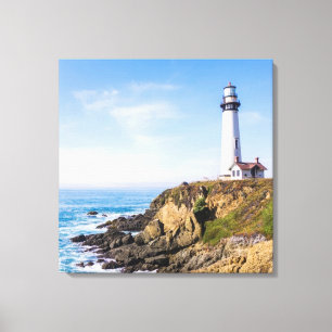 Lighthouse on hill blue sky white house ocean canvas print