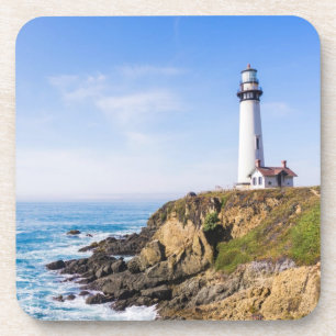 Lighthouse on hill blue sky white house ocean coaster