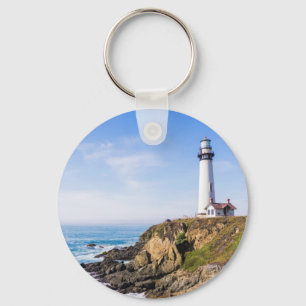 Lighthouse on hill blue sky white house ocean key ring
