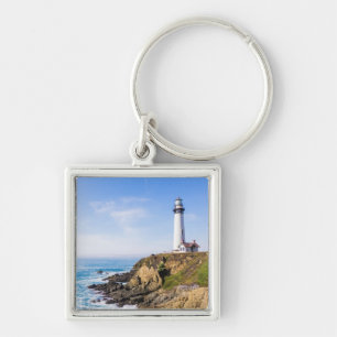 Lighthouse on hill blue sky white house ocean key ring