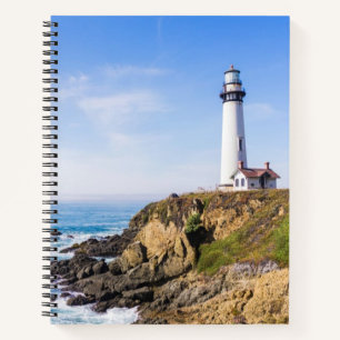 Lighthouse on hill blue sky white house ocean notebook