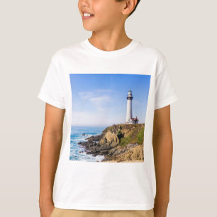 Lighthouse on hill blue sky white house ocean T-Shirt