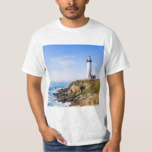 Lighthouse on hill blue sky white house ocean T-Shirt