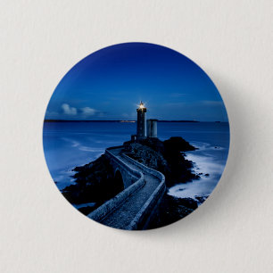 Lighthouse on wall in ocean at night 6 cm round badge