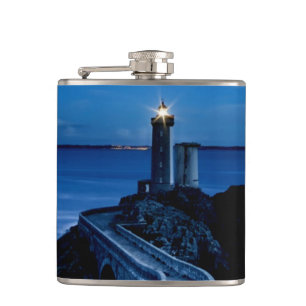 Lighthouse on wall in ocean at night hip flask