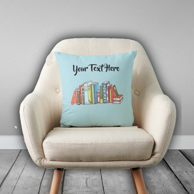 Line of Numerous Colourful Books on Light Blue Cushion (Row of multiple colourful books on light blue decorative pillow for avid readers.)