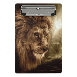 Lion against stormy sky mini clipboard