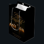 Lit Menorah Elegant Black & Gold Happy Hanukkah Medium Gift Bag<br><div class="desc">This beautiful black and gold gift bag features an artistic photograph of a lit menorah shot from below giving it a very dramatic look. The text is an elegant lacy script reading Happy Hanukkah. Wonderful way to send holiday cheer.</div>