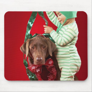 Little boy decorating a dog mouse mat