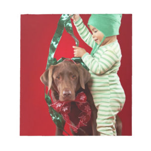 Little boy decorating a dog notepad