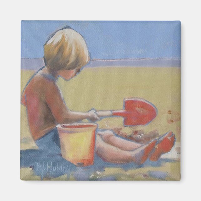 Little boy playing in the sand with a shovel magnet (Front)