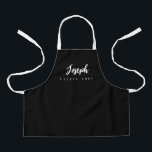 Little Chef Script Name personalised Black Apron<br><div class="desc">Make your little chef feel extra special with our Little Chef Script Name Personalised Kids black Apron. This apron is designed to provide a simple, chic, and elegant look, featuring stylish script typography for personalising the name. The purple background colour adds a touch of vibrancy and fun, perfect for engaging...</div>