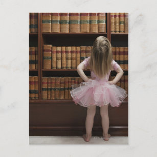 little girl in tutu reading book covers in postcard