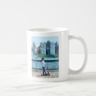 Little Girl on Scooter by Manhattan Skyline Coffee Mug