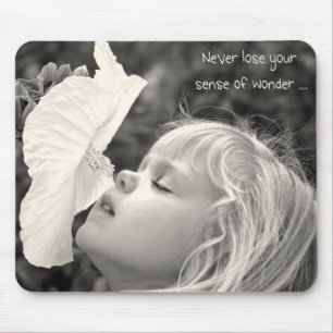 Little girl smelling hibiscus mouse mat