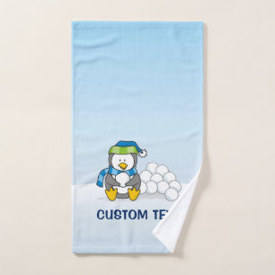 Little penguin sitting with snowballs bath towel set
