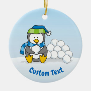 Little penguin sitting with snowballs ceramic tree decoration