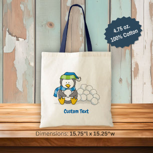 Little penguin sitting with snowballs tote bag