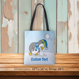 Little penguin walking on snow tote bag