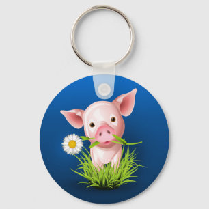 Little pink pig in green grass over blue key ring