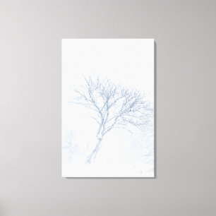 Lonely tree during snow storm in winter canvas print
