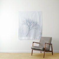 Lonely tree during snow storm in winter