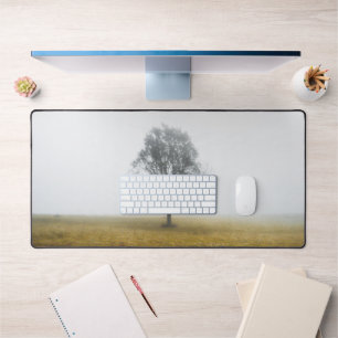 Lonely tree in a foggy autumn morning desk mat