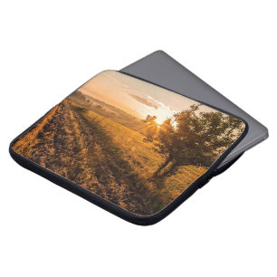 Lonely tree on the foggy field in golden sunrise laptop sleeve