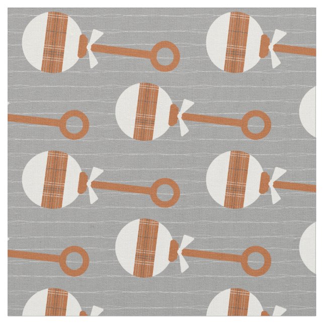 Longhorn Burnt Orange Plaid Baby Rattle on Gray Fabric (Close Up)