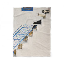 Lot of cats on a white stairway in a Greek village