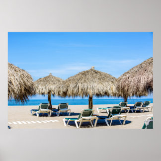 Lounge Chairs And Thatch Umbrellas On Beach Poster