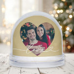 Love in Script Gold Heart Photo Snowglobe<br><div class="desc">This luxurious snow globe features your favourite couple's photo framed inside a warm gold heart cutout with "Love" in delicate white script. The back displays a second photo for a two-sided keepsake with golden elegance. A beautiful Valentine's Day gift, anniversary celebration memento, or romantic keepsake with a warm metallic glow....</div>
