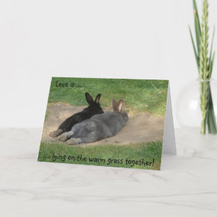 Love is ...., .... lying on the warm grass toge... card